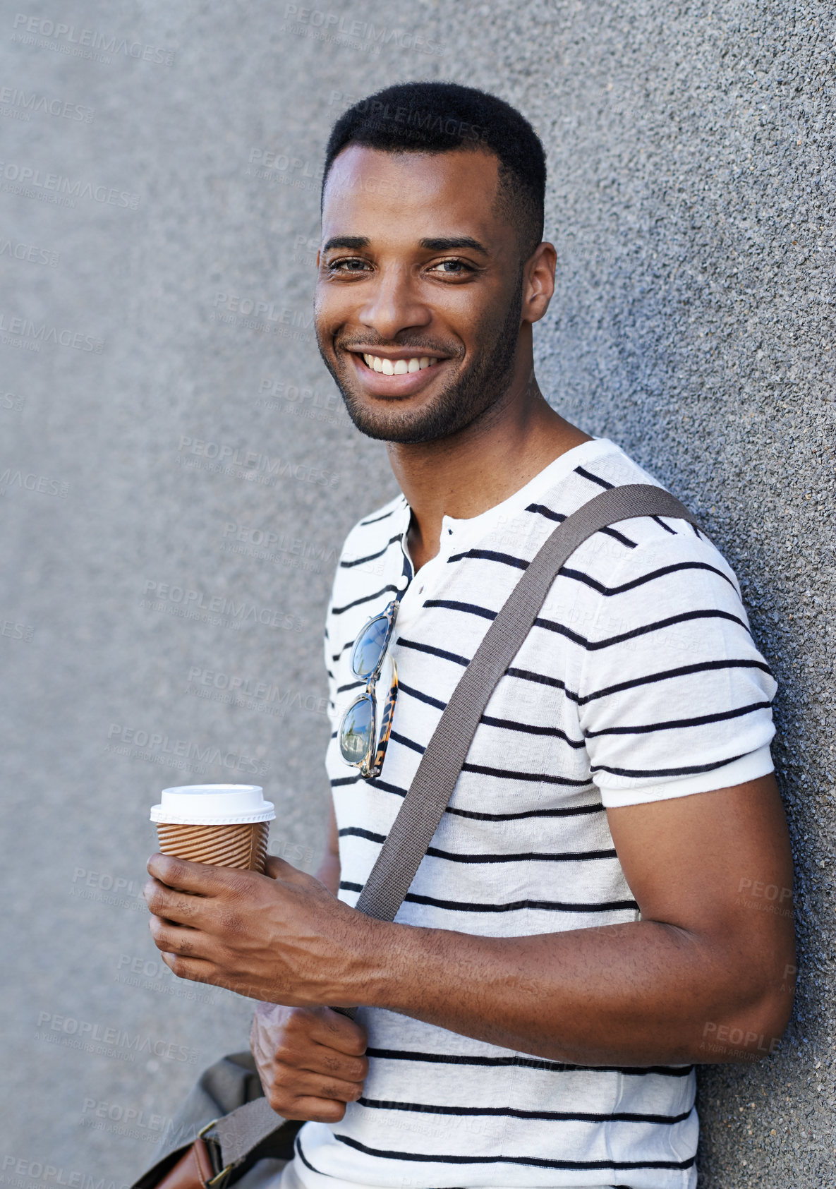 Buy stock photo City, wall and black man in portrait with coffee, hot beverage and confidence with smile in morning. Outdoor, male employee and espresso for drinking, caffeine and happiness to travel in France