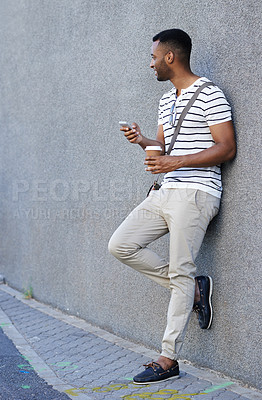 Buy stock photo Black man, coffee and phone in city for texting, social media and scroll online in outdoor. Male person, profile and app for communication in town by wall background, chat and tea on commute or email