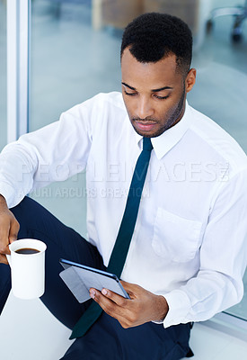 Buy stock photo Businessman, tablet and reading in office with coffee, digital app and research for investing. Realtor, technology and internet for streaming video or news for career in morning or real estate agency