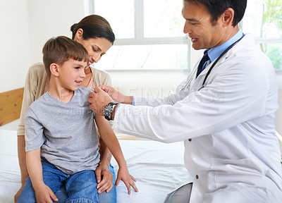 Buy stock photo Shot of a doctor getting ready to examine his young patient