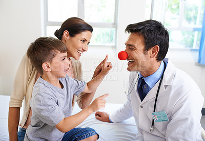 Buy stock photo Cropped shot of a doctor entertaining his patients 