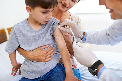 Buy stock photo A doctor administering an injection to an adorable young boy