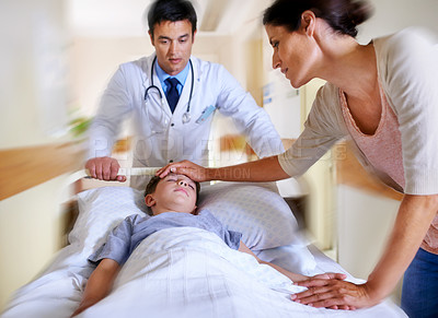 Buy stock photo Cropped shot of a patient being wheeled away by his doctor and mother