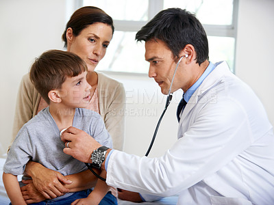 Buy stock photo Shot of a concerned doctor examining a young patient