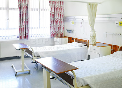 Buy stock photo Interior shot of beds in a hospital ward