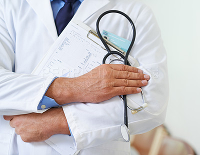 Buy stock photo Closeup shot of a doctor holding a patient chart and a stethoscope