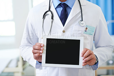 Buy stock photo Closeup of a doctor holding up a tablet so that the screen faces the camera