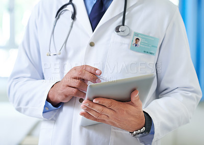 Buy stock photo Closeup shot of a doctor using a tablet