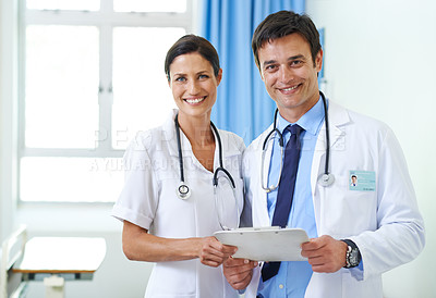 Buy stock photo Portrait of a smiling medical team checking a patient's chart