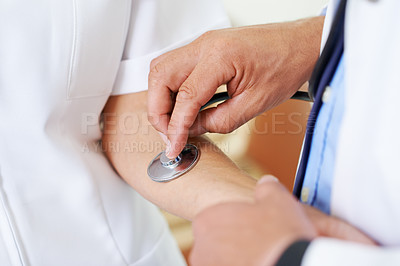 Buy stock photo Closeup shot of a doctor using a stethoscope to check a woman's heart rate