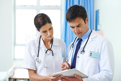 Buy stock photo Doctors, talking and tablet for healthcare team on clinic website, update and review medicine. People, speaking and medical support for treatment or diagnosis, surgery schedule and hospital news