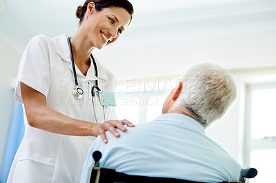 Buy stock photo Shot of a beautiful young female doctor talking to her senior patient