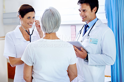 Buy stock photo Hospital, talking and doctor with old person, smile and medical employees with patient and conversation. Healthcare, wellness and nurse with discussion of care of elderly woman, illness and clipboard