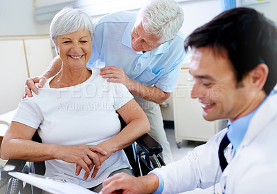 Buy stock photo Shot of a senior couple getting good news from their doctor