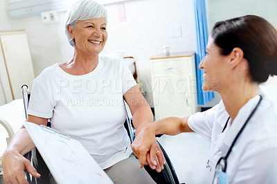 Buy stock photo Shot of a beautiful young doctor giving her senior patient good news