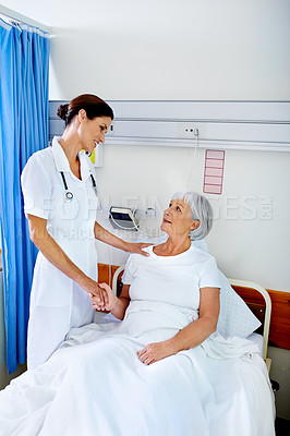 Buy stock photo Hospital room, smile and care of nurse, old woman and communication for health of patient and medical. Clinic, wellness and employee with senior person, holding hands or conversation in appointment