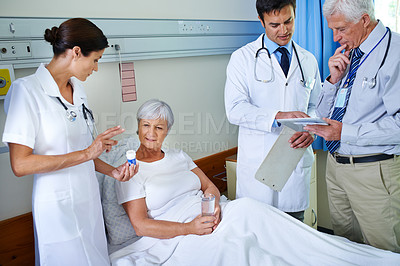 Buy stock photo Hospital, pills and doctors with old woman, explaining or communication for health of patient or medical. Clinic, wellness and nurse with senior person, water or medicine in appointment of healthcare