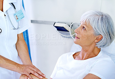 Buy stock photo Shot of a doctor comforting her senior patient who is in a hospital bed