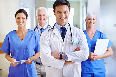 Buy stock photo Portrait of a smiling medical team standing in a hospital corridor