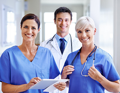 Buy stock photo Portrait of a smiling medical team standing in a hospital corridor