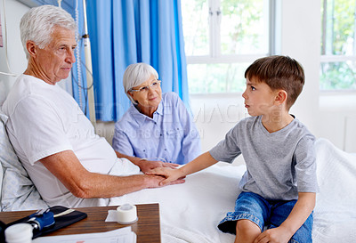 Buy stock photo Grandfather, kid and support in clinic bed for kindness, rehabilitation or medical healthcare with family. Grandpa, child and holding hands in hospital for comfort, care or empathy for sick patient.