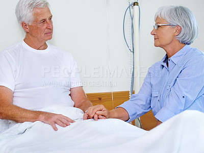 Buy stock photo Senior couple, support and holding hands in hospital for visit, love relationship and empathy. Old man, elderly woman and compassion for medical injury with trust, care and sorry for cancer diagnosis