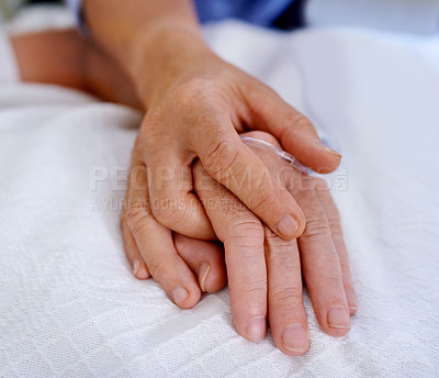 Buy stock photo Closeup shot of hands clasped in unity and comfort on a hospital bed