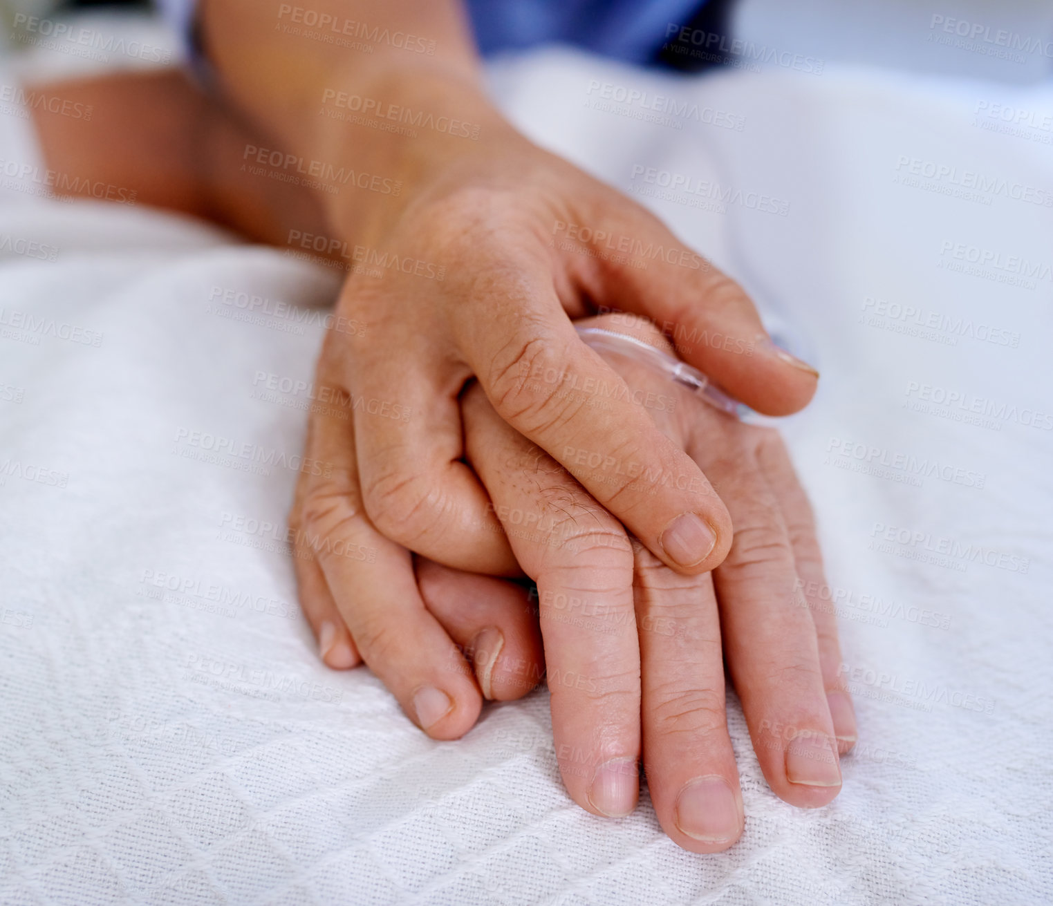 Buy stock photo Closeup shot of hands clasped in unity and comfort on a hospital bed