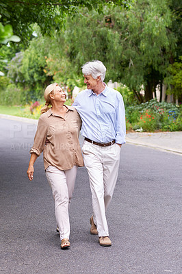 Buy stock photo Shot of a happy senior couple walking