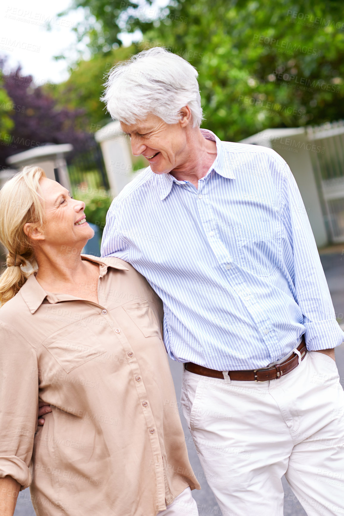 Buy stock photo Romantic, road or senior couple walking to relax or enjoy bonding together in retirement for peace. Happy, mature woman and elderly man on street with care, support or smile in quiet neighborhood