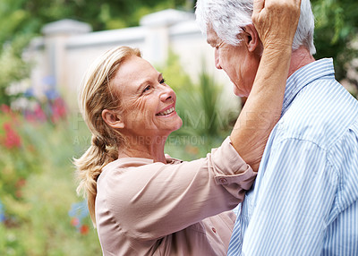 Buy stock photo Shot of a old couple glazing intimately at each other