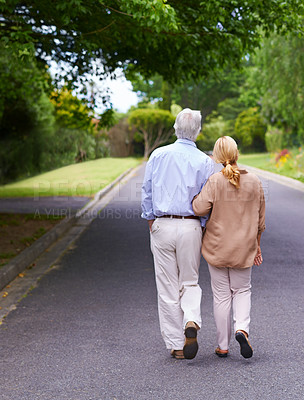 Buy stock photo Rearview shot of senior couple taking a walk together