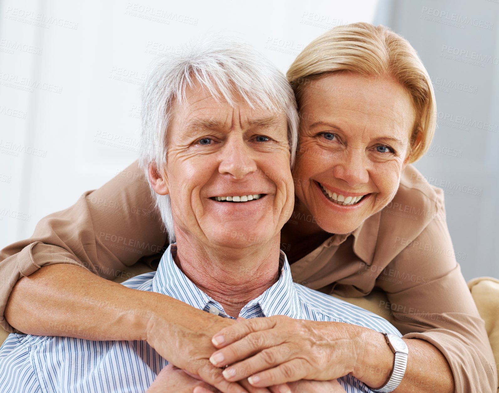 Buy stock photo Senior, portrait and happy couple hug in home for love, support and bonding together in lounge. Face, man and woman embrace for connection, trust or commitment for marriage with partner in retirement