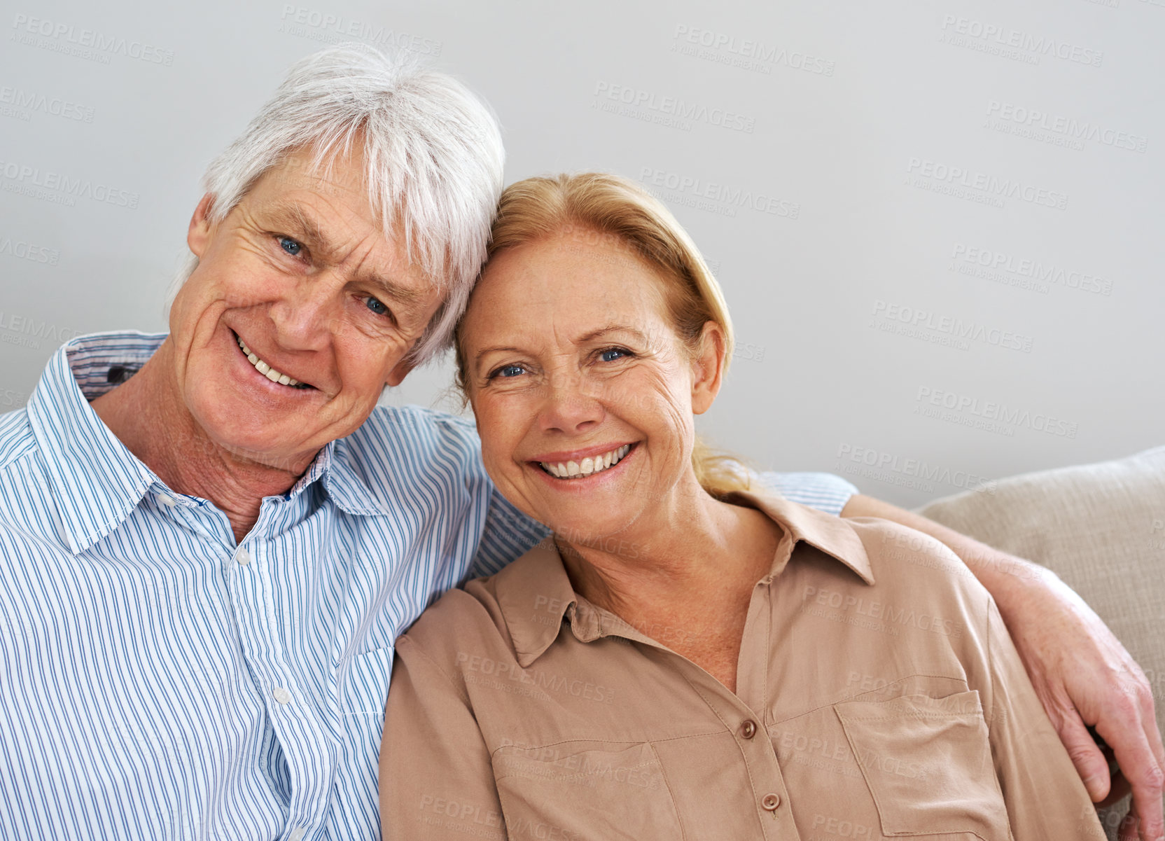 Buy stock photo Smile, hug and portrait of senior couple in home for love, support or care together in living room. Face, man and happy woman embrace for connection, loyalty or commitment with partner in retirement