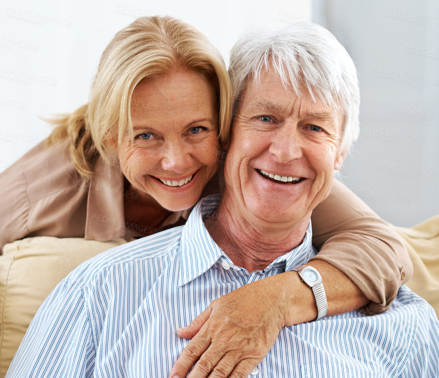 Buy stock photo Senior, portrait and happy couple hug in house for love, support or laugh together in lounge. Face, man and woman embrace for connection, trust or commitment for marriage with partner in retirement