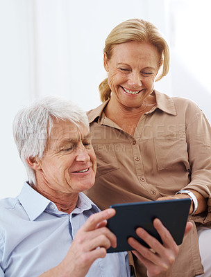 Buy stock photo Cropped shot of senior couple using their digital tablet