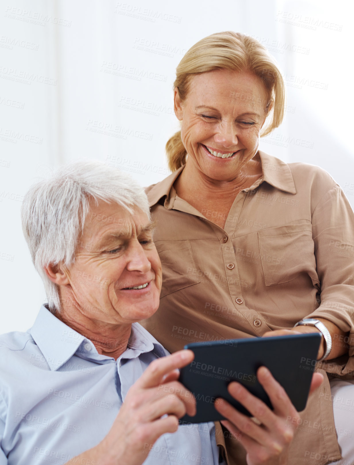 Buy stock photo Cropped shot of senior couple using their digital tablet