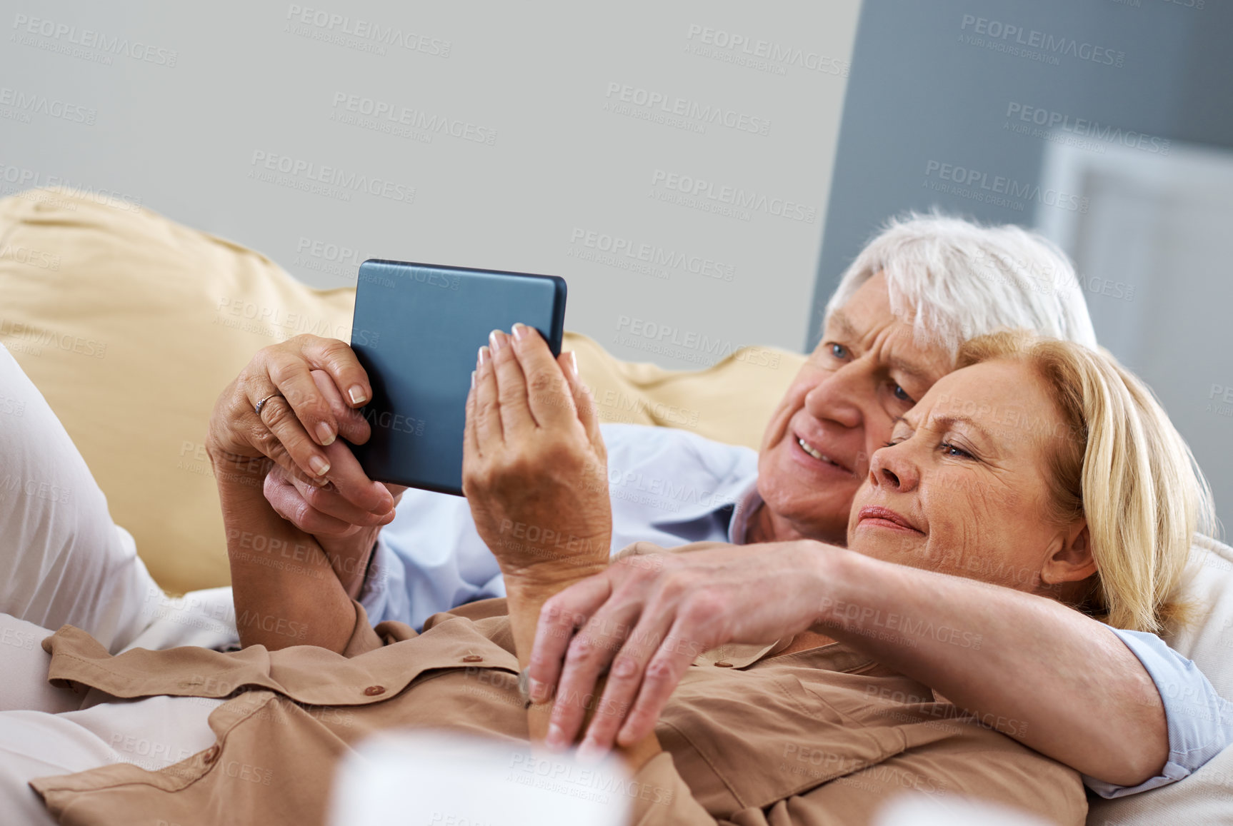 Buy stock photo Home, tablet and old couple with conversation, relax or retirement with connection and comfort on sofa. Apartment, senior man or mature woman with technology, network or digital app for communication