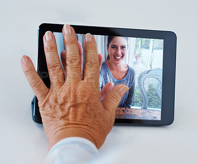 Buy stock photo Shot of a grandmother longing for her grandchild while video conferencing