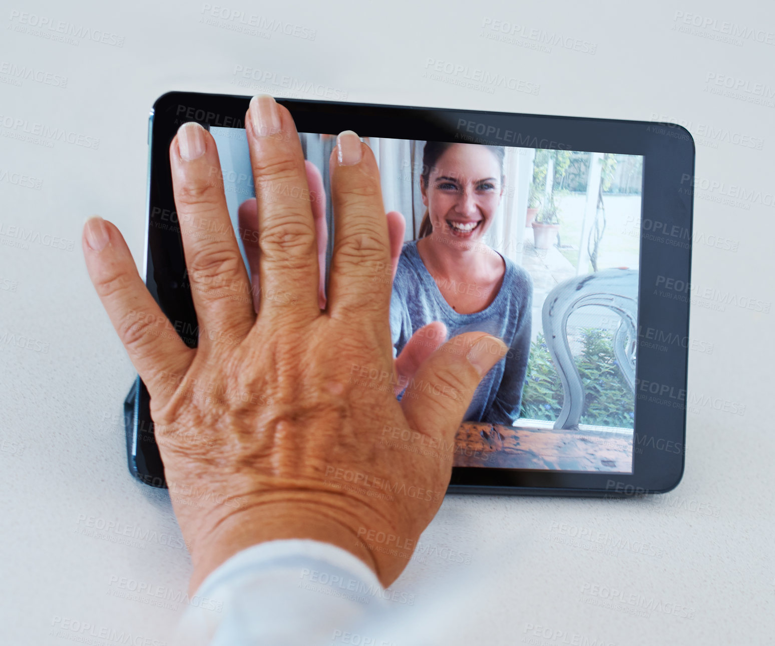 Buy stock photo Shot of a grandmother longing for her grandchild while video conferencing