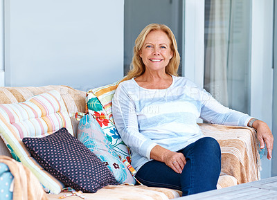 Buy stock photo Portrait of a senior woman relaxing on her outdoor furniture