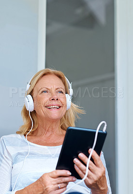 Buy stock photo Tablet, smile and senior woman in patio, happy and headphones for movies, thinking and relax in retirement. Watch, online and old person with subscription of app, film and grandma with peace in home