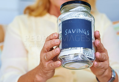 Buy stock photo Savings, dollars and hands or jar in home for finance or cash for investment and retirement. Security, paper and senior person in living room or lounge with budget, money and notes or goal for wealth