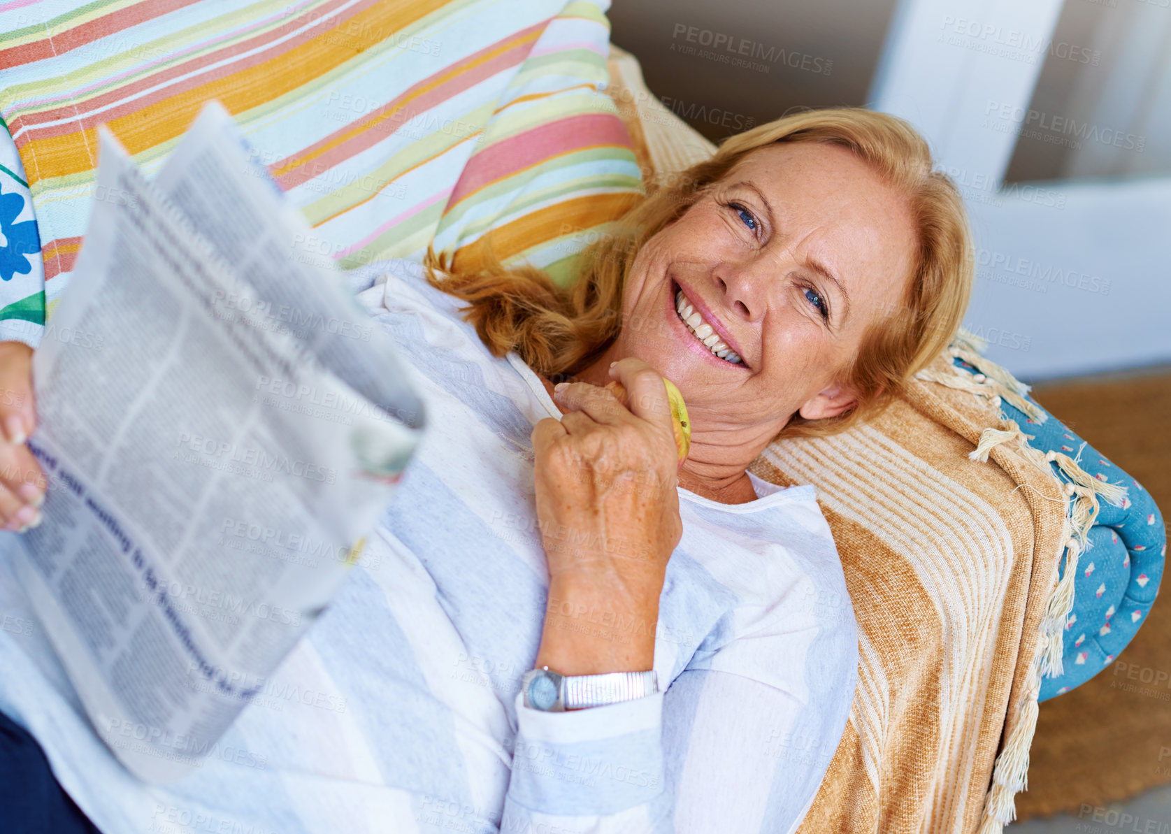 Buy stock photo Happy, newspaper and senior woman on patio, couch and portrait with smile in retirement, calm and house. Backyard, information and old person with peace on sofa, relax and grandma with joy in home