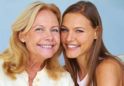 Buy stock photo Shot of a young woman sitting next to her grandmother