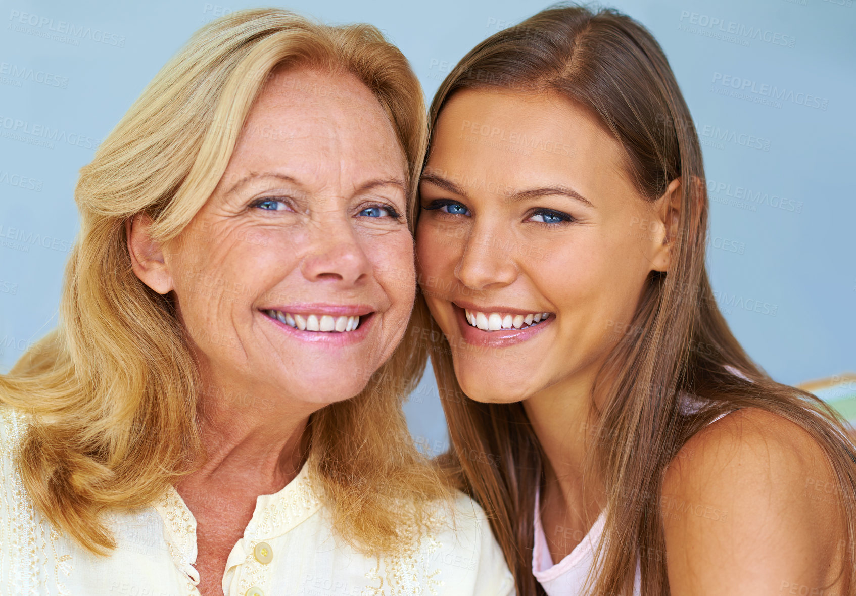 Buy stock photo Shot of a young woman sitting next to her grandmother