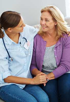 Buy stock photo Shot of a young nurse talking to her senior patient