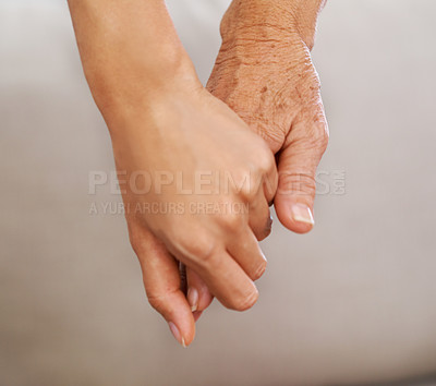 Buy stock photo Closeup of young and old woman holding hands and spending time together. A kind, loving female or nurse holding the hand of senior lady, showing kindness and care. Friends, unity and trust