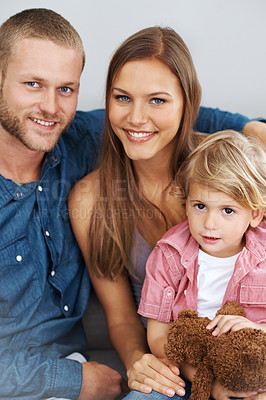 Buy stock photo Shot of a young couple sitting with their little boy