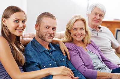 Buy stock photo Shot of a happy family sitting together indoors